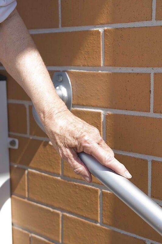 Man Holding the Handrail — Home Modification Services In Byron Bay, NSW