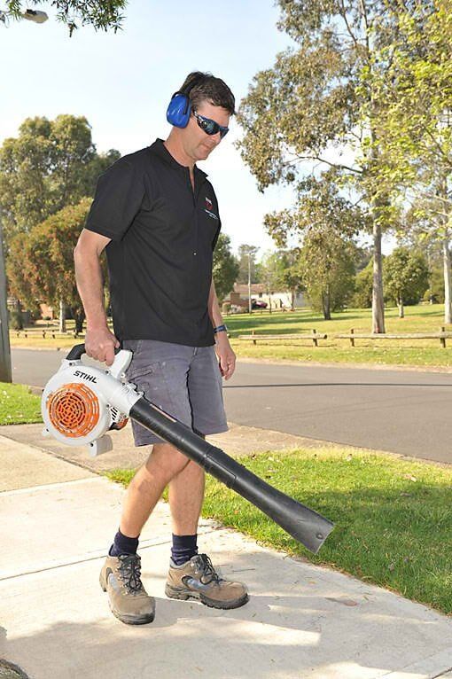 Man Holding Grass Blower — Home Modification Services In Byron Bay, NSW