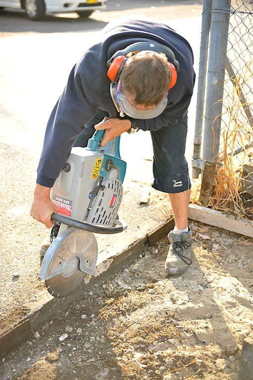 Man Using Concrete Cutting Machine — Home Modification Services In Byron Bay, NSW