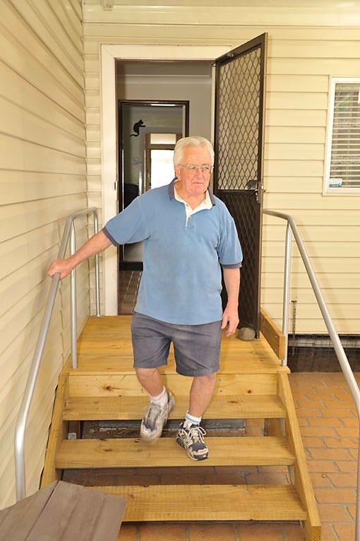 Man Standing in Wooden Steps — Home Modification Services In Byron Bay, NSW
