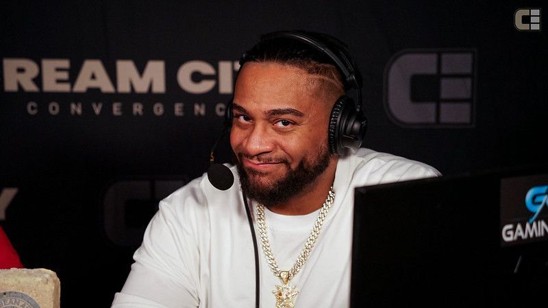 A man and a woman are sitting in front of computer monitors.