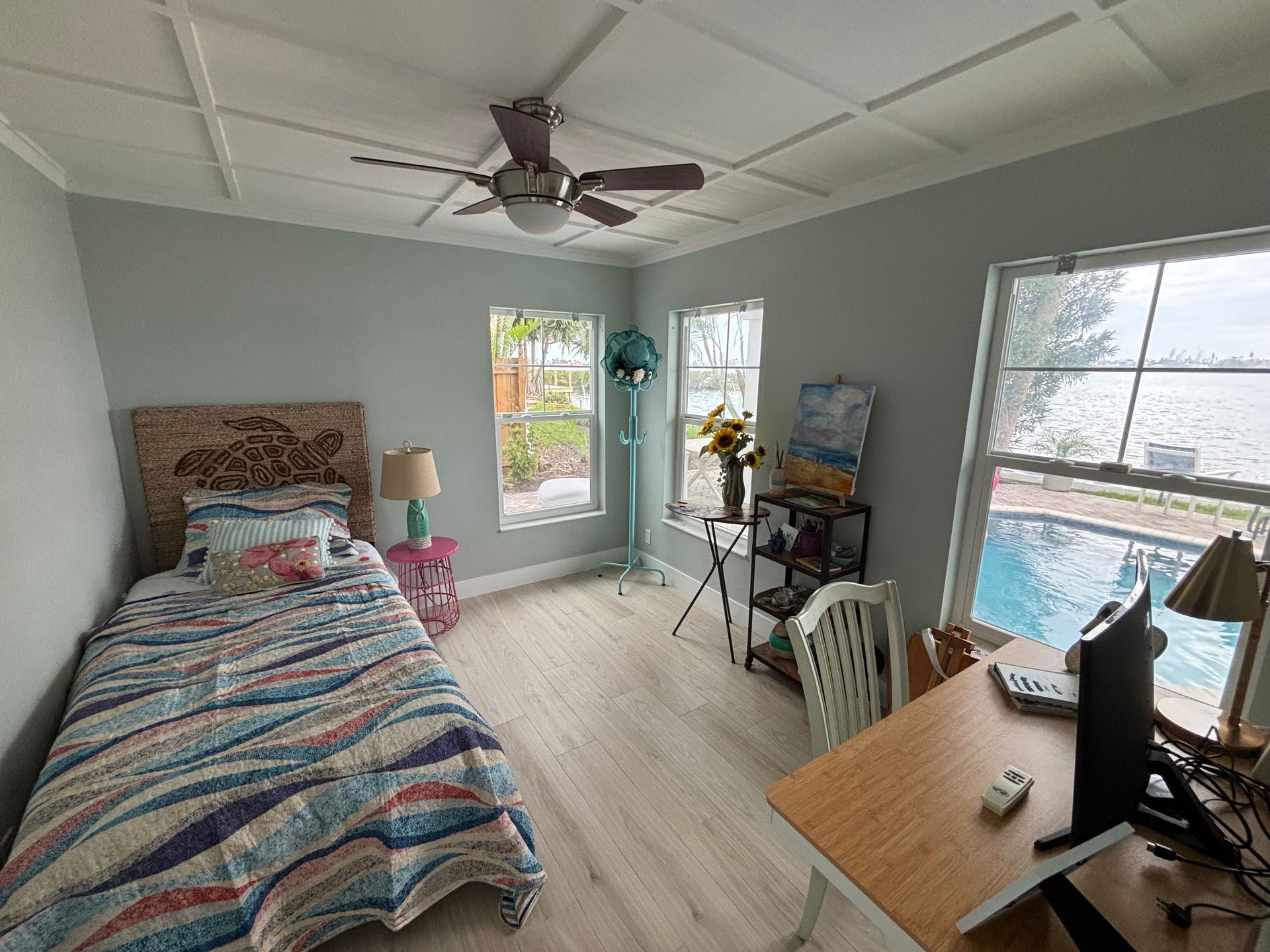 Room under renovation with brown doors, a ladder, and materials.