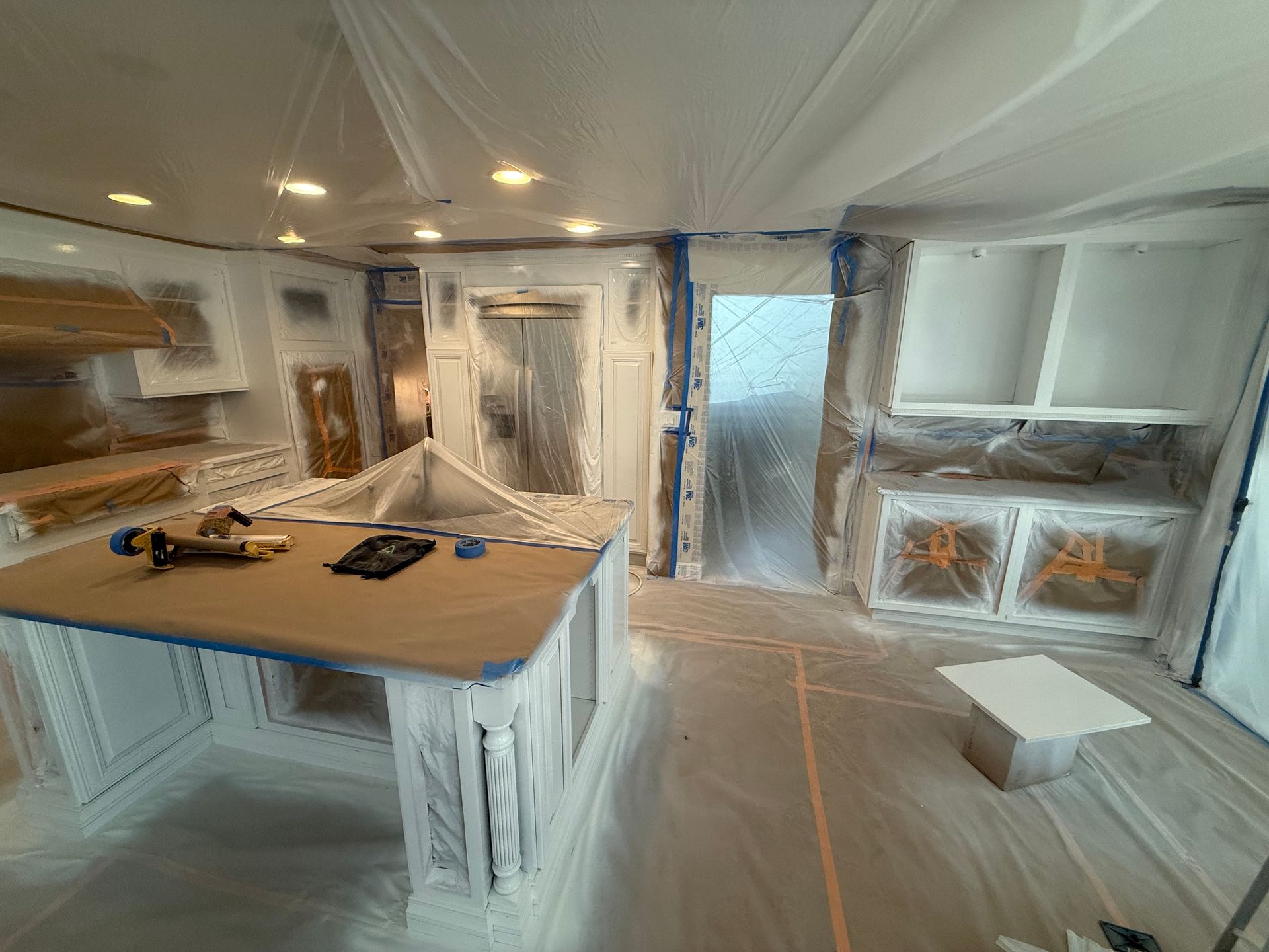 Person staining a wooden door with a paintbrush, brown color.