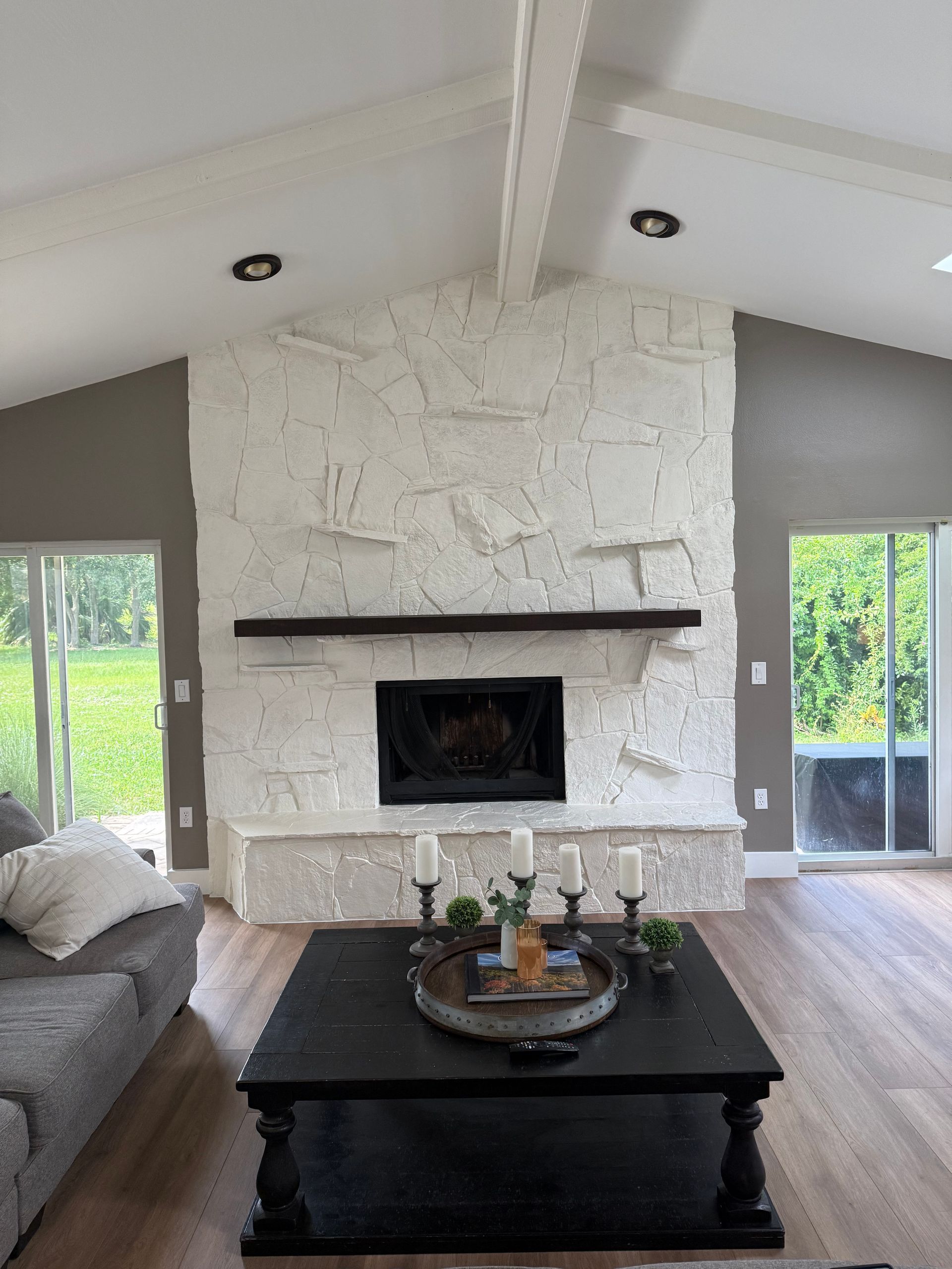 Interior of a house under construction, showing drywall walls and ceiling, unfinished, with window and doorways.