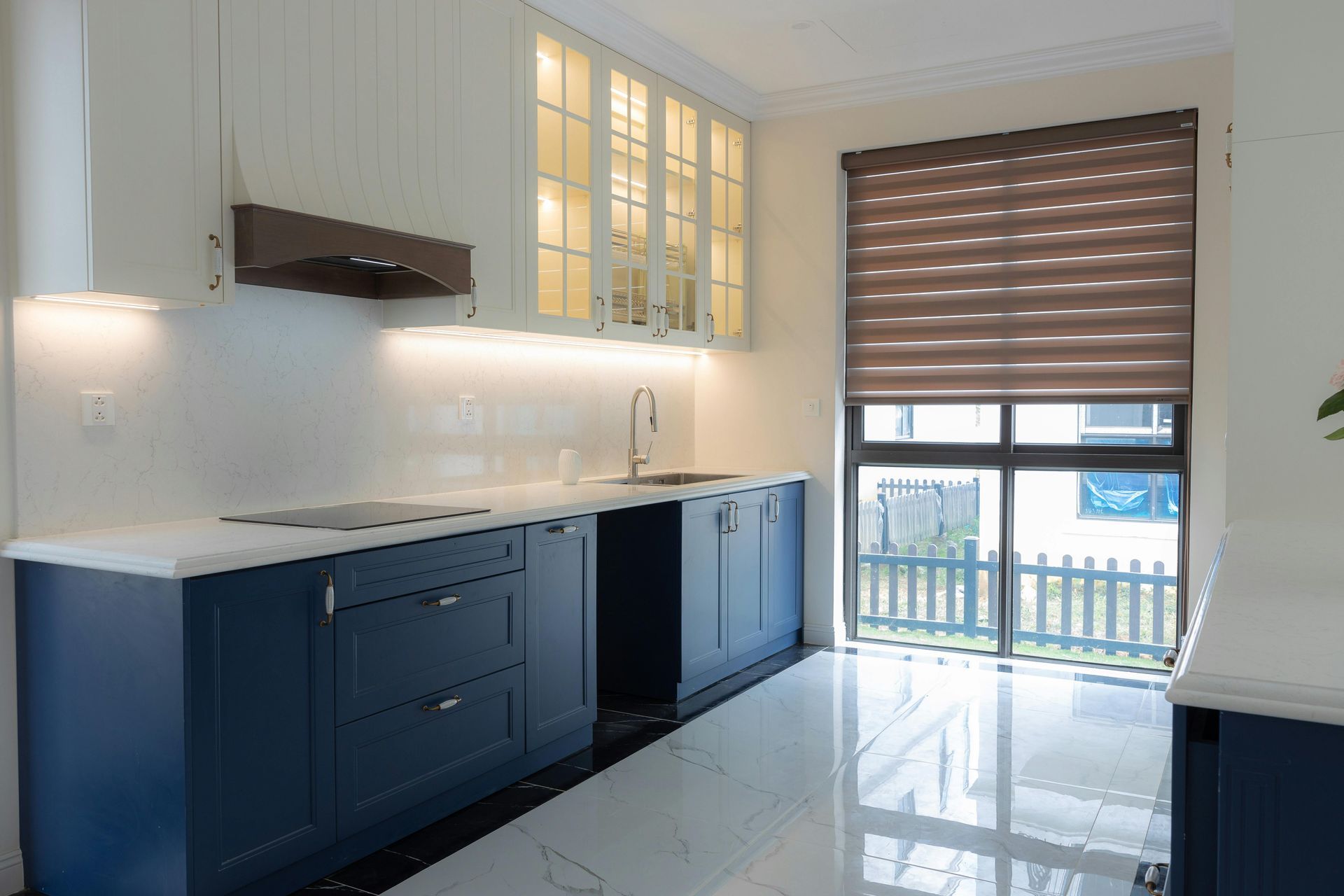 Two men are working on a bathroom and a living room in a house.