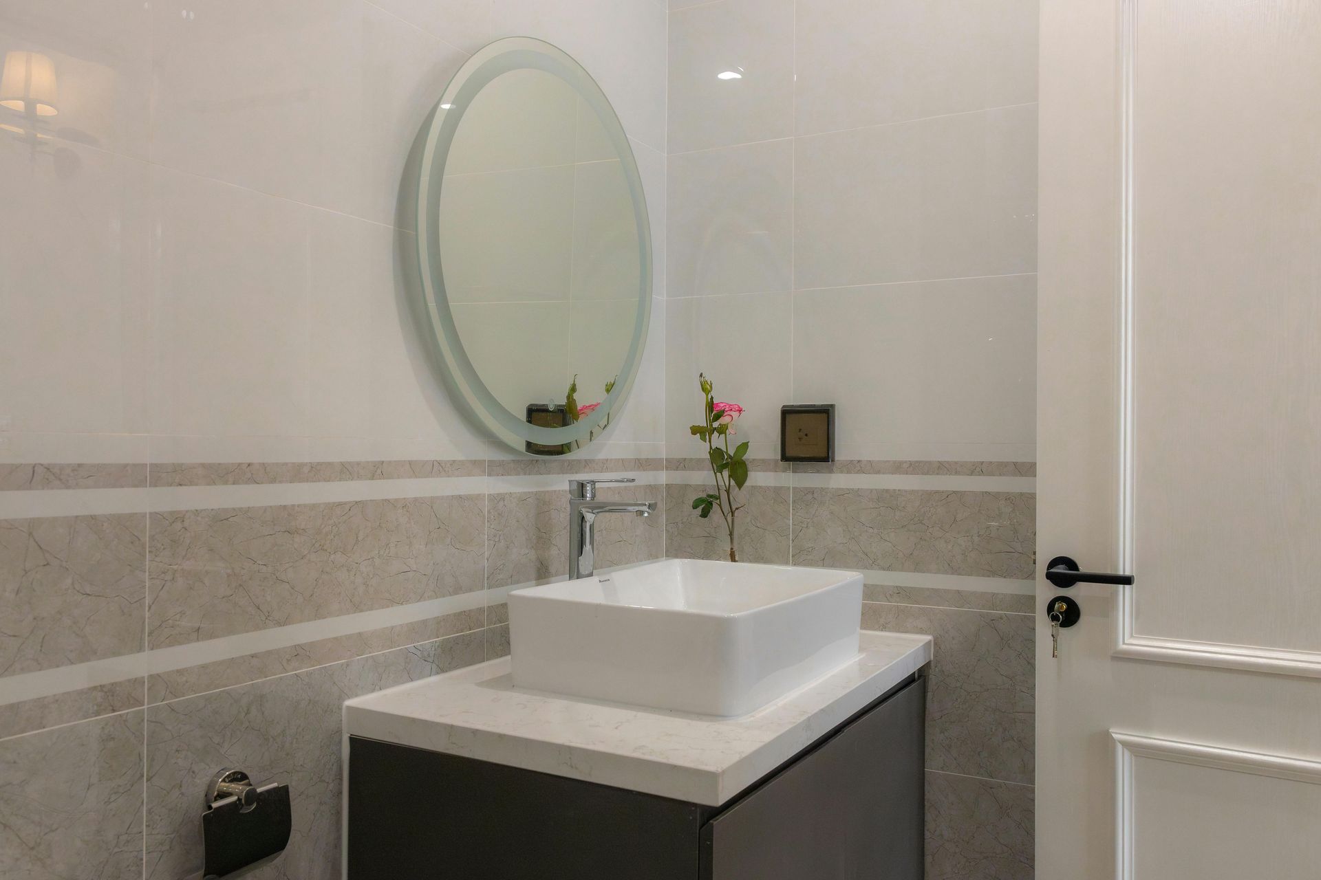 A construction worker is measuring a piece of wood in a kitchen.