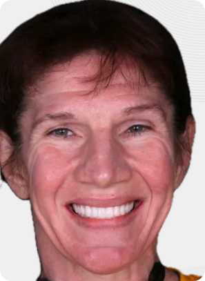 Woman smiling, showing teeth, with reddish-brown hair.