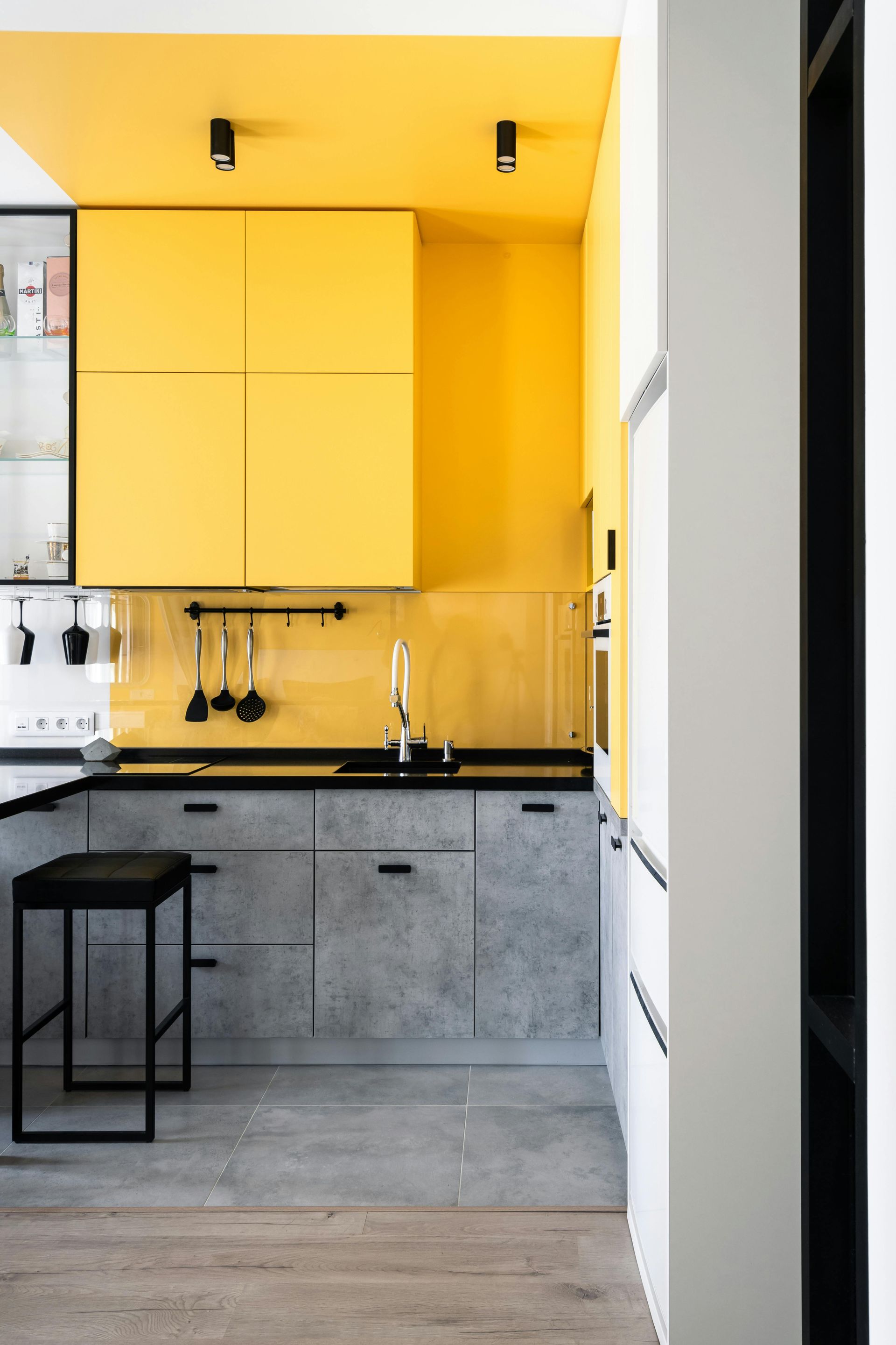 Kitchen cabinets in Sierra Vista home refinished with bold yellow paint for a modern updated look.