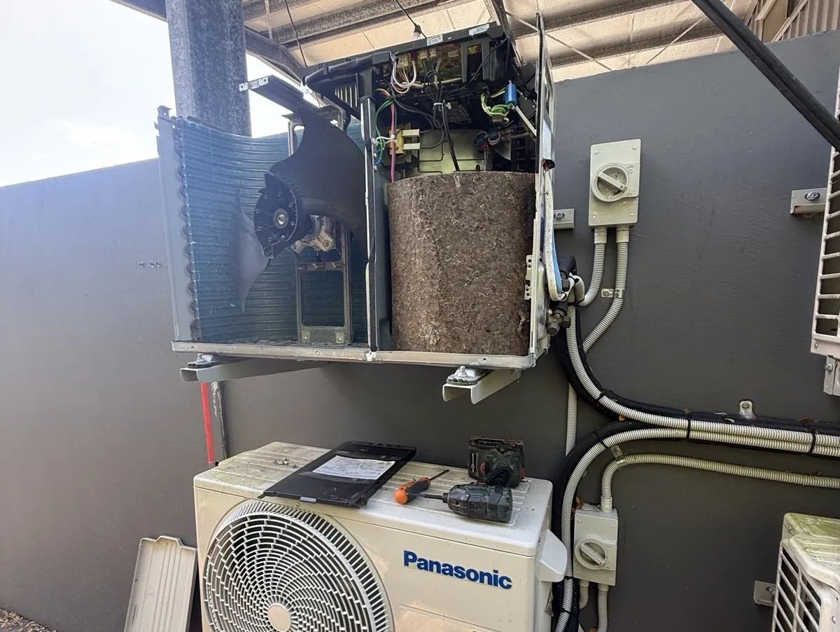 Air Conditioner With Exposed Internal Components — Frostys Air-Conditioning Services in Cannonvale, QLD
