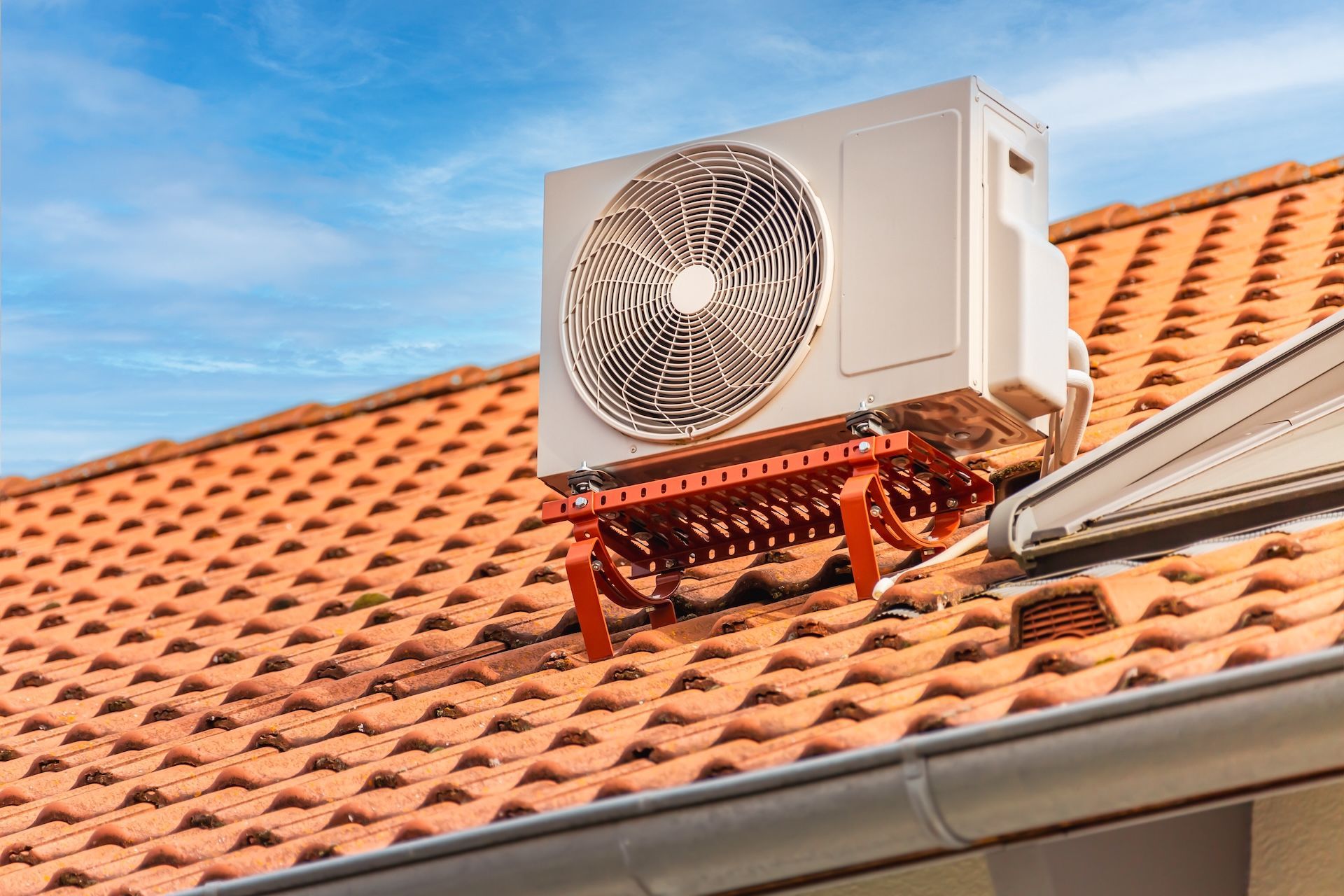 Outdoor Panasonic air conditioning unit mounted on a light-colored wall.— Frostys Air-Conditioning Services in Cannonvale, QLD