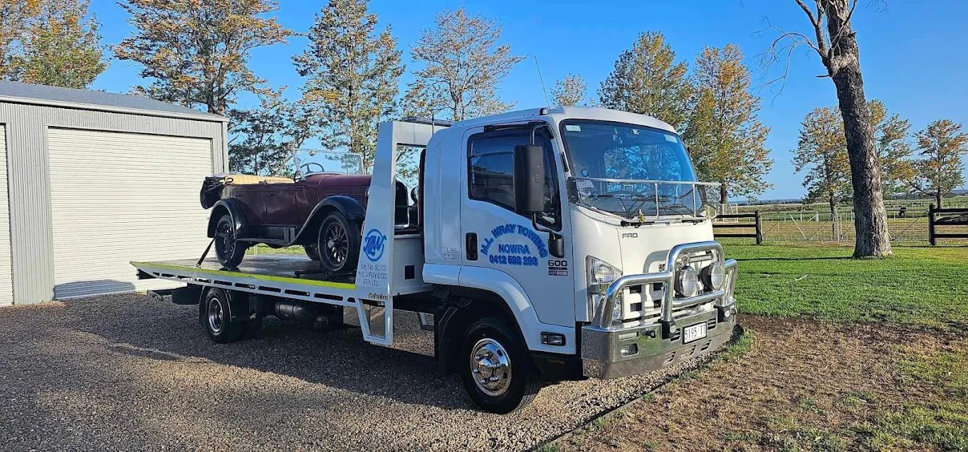 A Red Ferrari Testarossa is on a Tow Truck — M.L. Wray Towing & Automotive Repairs in Nowra, NSW