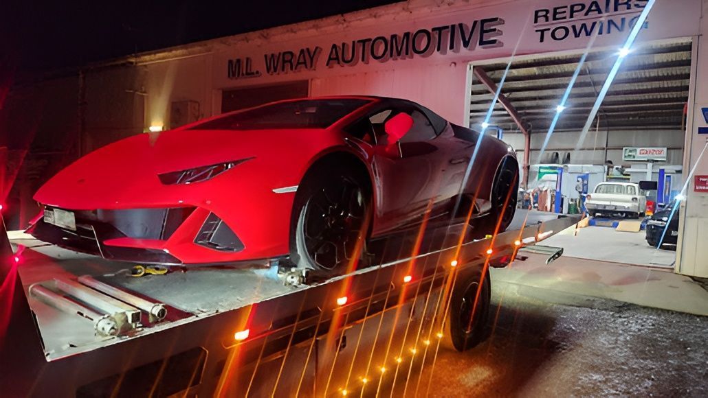 Red Lamborghini on a Tow Truck Outside — M.L. Wray Towing & Automotive Repairs in Nowra, NSW