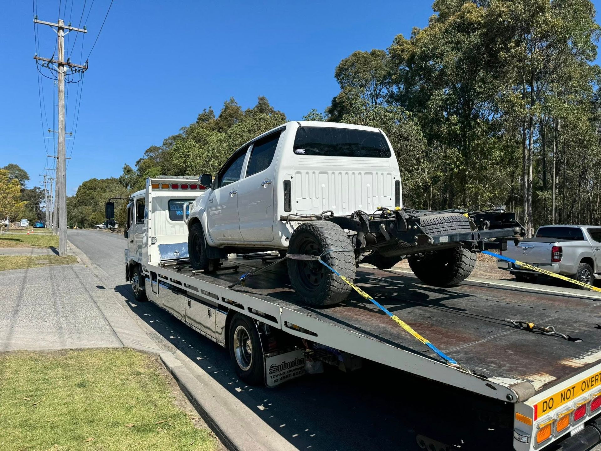 White Truck Cab and Chassis on a Flatbed Tow Truck — M.L. Wray Towing & Automotive Repairs in Kiama, NSW