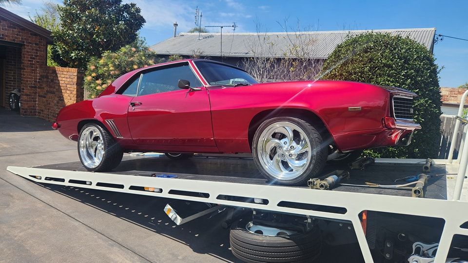 Red Classic Car on a Tow Truck, Shiny Paint — M.L. Wray Towing & Automotive Repairs in Nowra, NSW