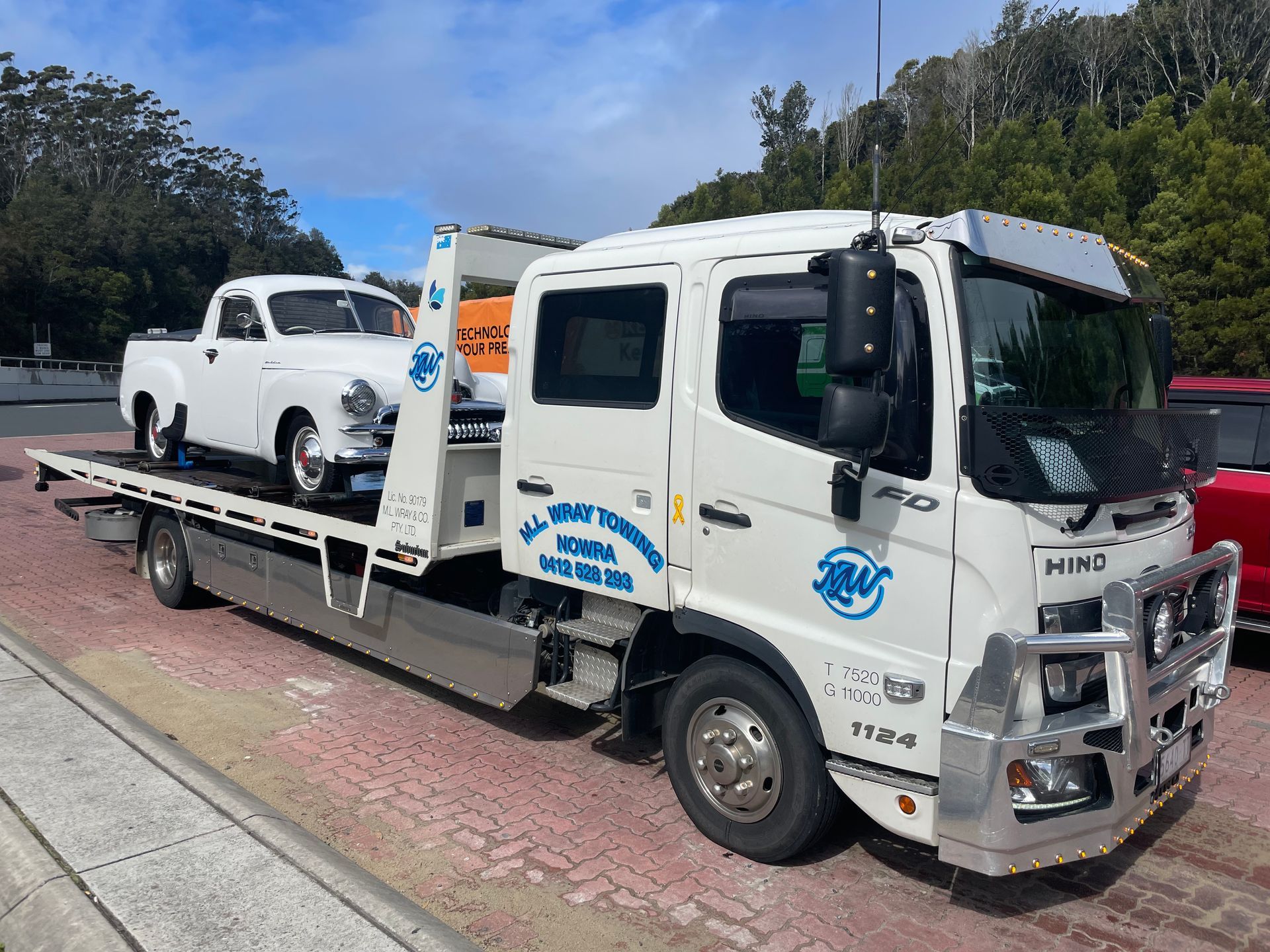 White tow truck with a classic white pickup truck on its bed. — M.L. Wray Towing & Automotive Repairs in Kangaroo Valley, NSW