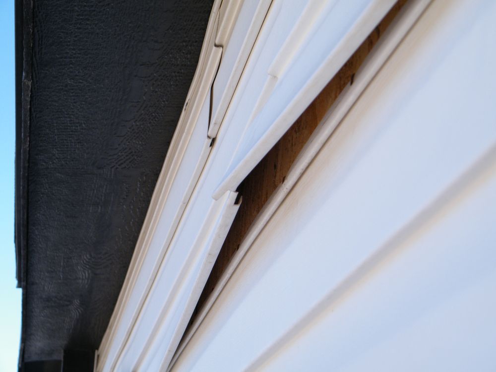 A close up of a white siding on a building
