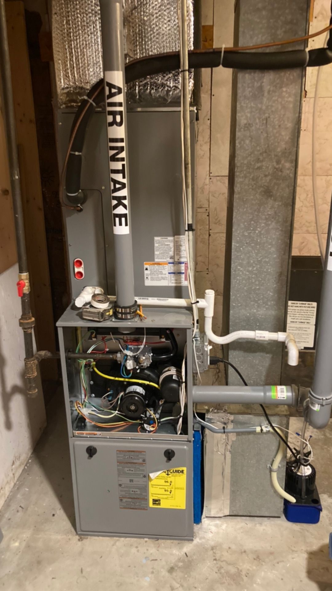A gas furnace in a basement. The 