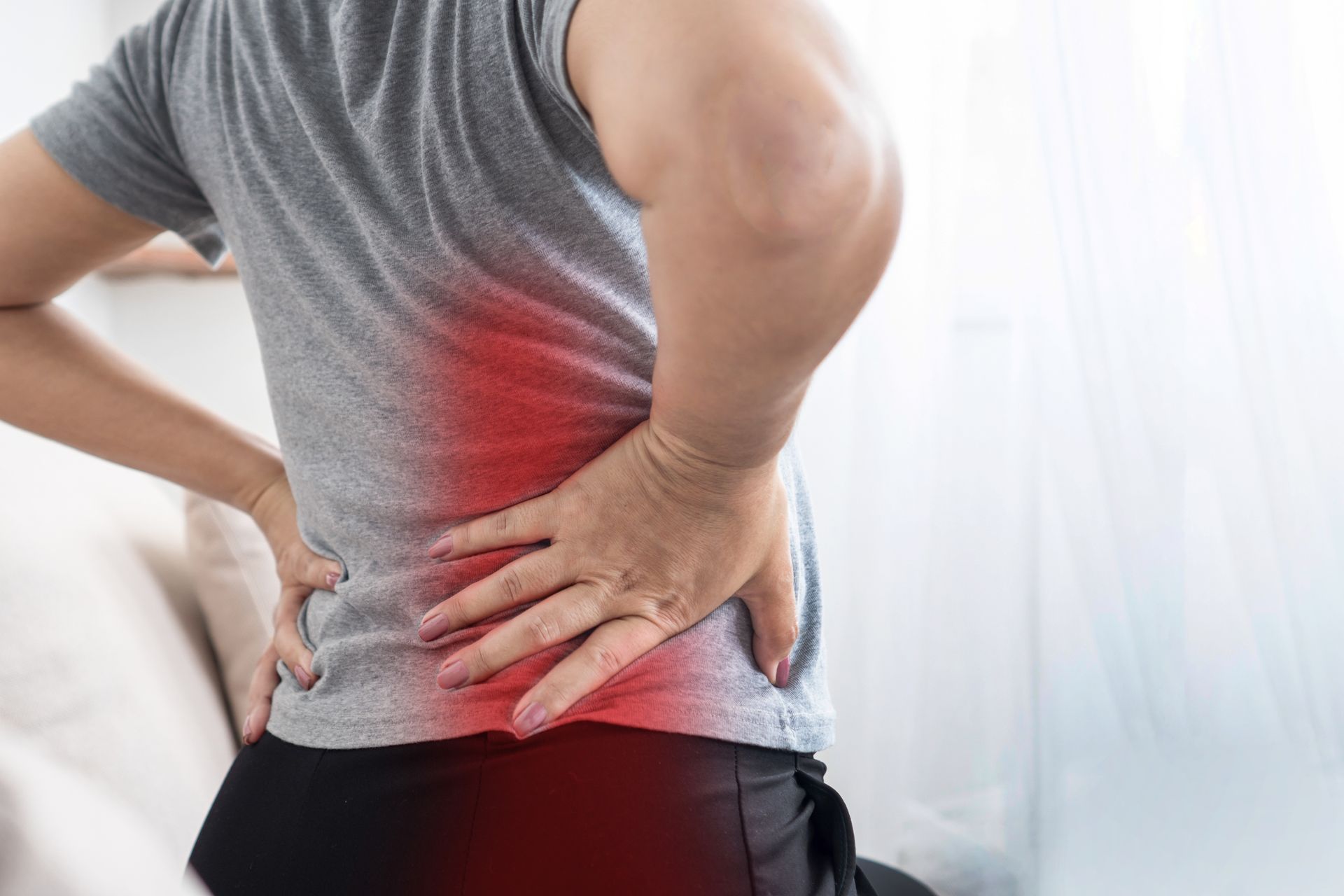 Person Holding Their Lower Back — Spinal Decompression Sunshine Coast In Mooloolaba, QLD