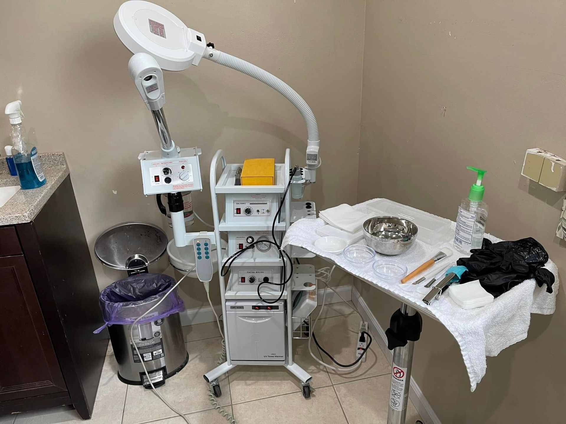 There is a table with a magnifying glass on it in a bathroom.