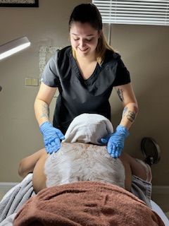 A woman is giving a man a massage in a spa.