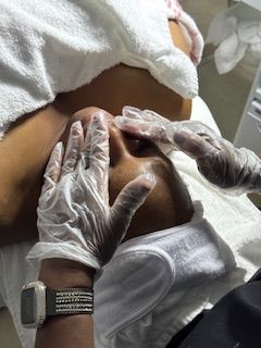 A woman is getting a facial treatment at a spa.