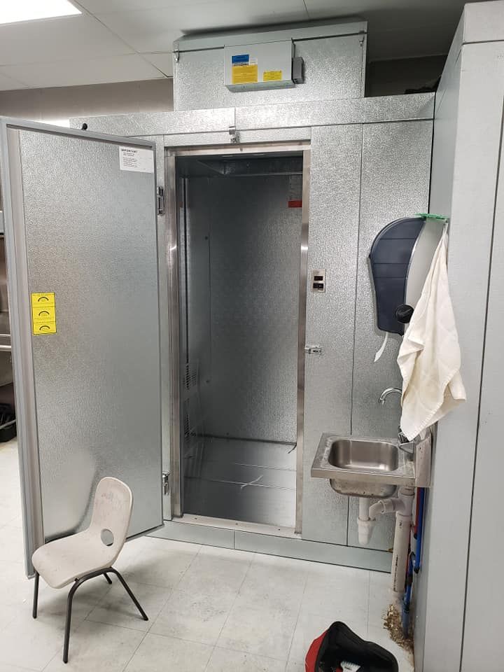 A room with a chair and a sink in it