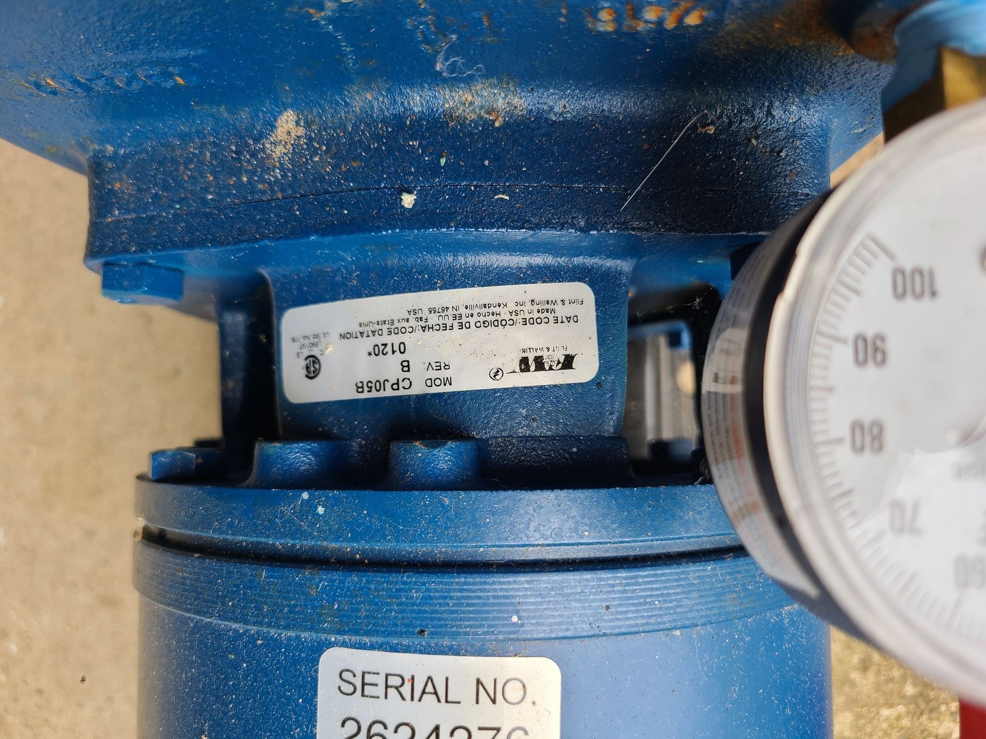A close up of a blue machine with a serial number