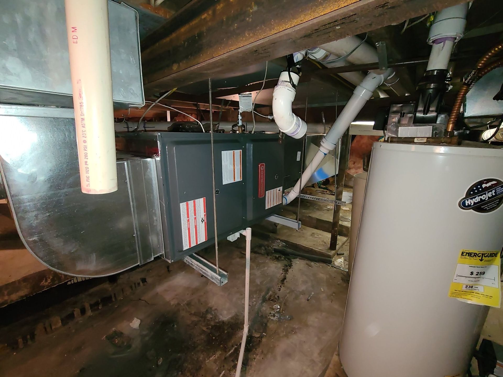 There is a water heater in the corner of the room.