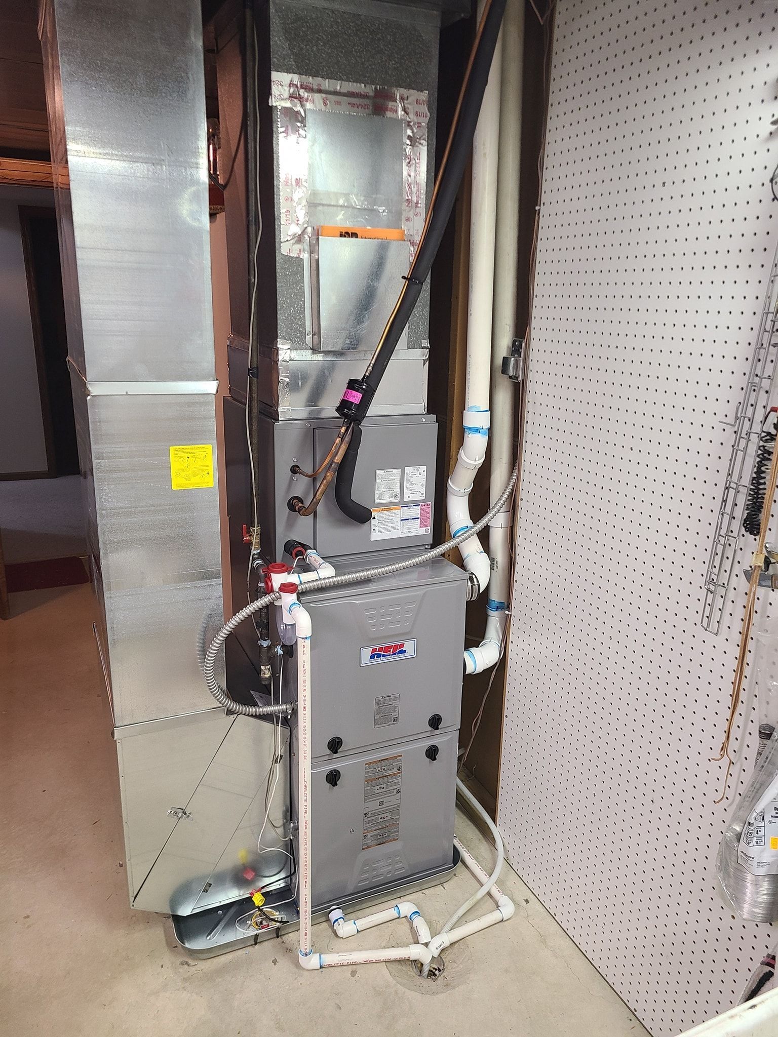 An air conditioner is sitting in a room next to a wall.