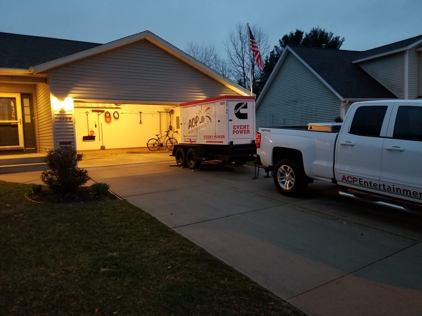 A white truck is parked in front of a house.