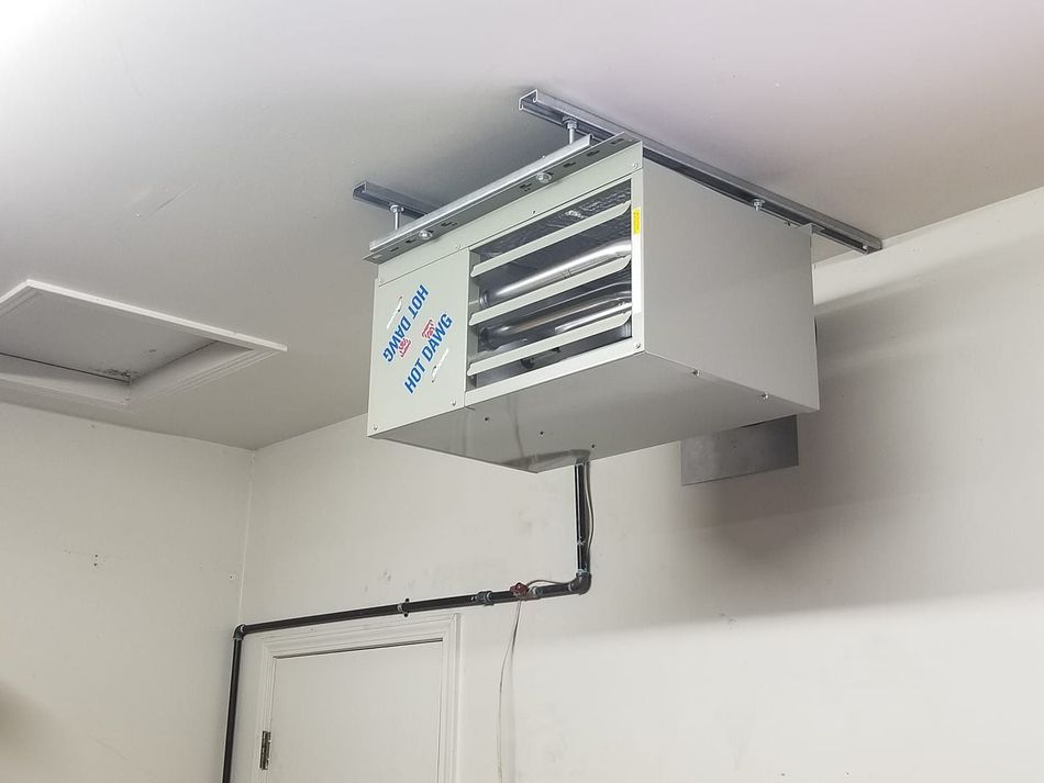 A white box is hanging from the ceiling of a room.