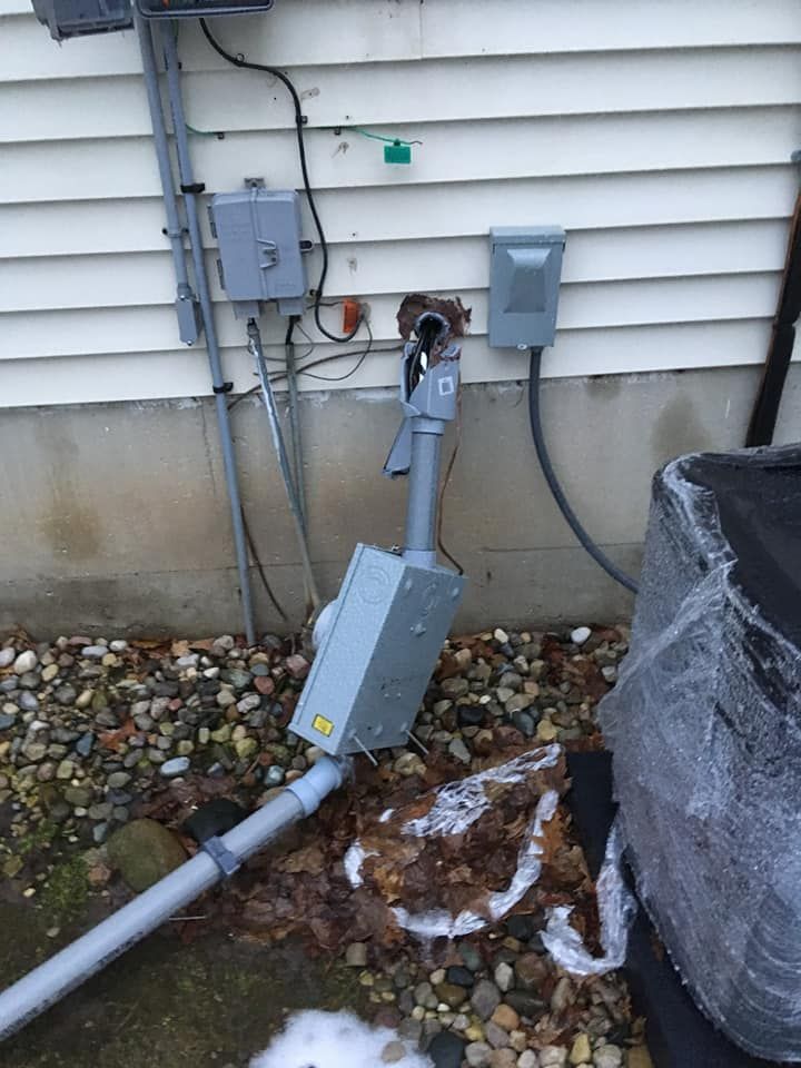 A broken box is sitting on the ground next to a house.