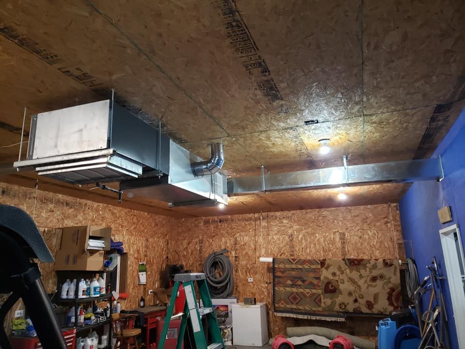 A garage with a ladder hanging from the ceiling.
