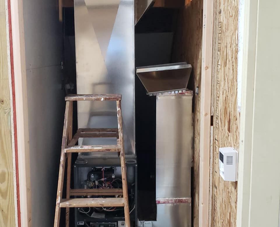 A ladder is leaning against a wall next to a heater.