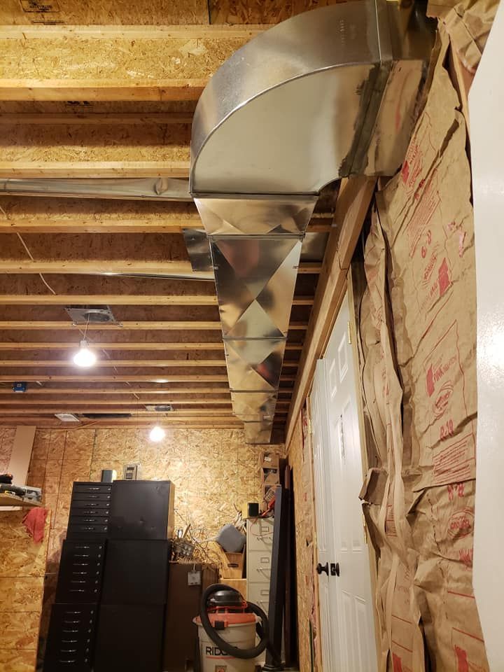 A metal pipe is hanging from the ceiling of a room.