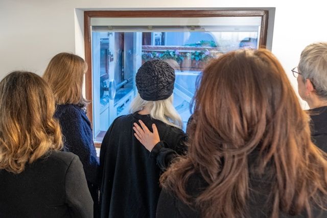 A family witnessing a cremation service