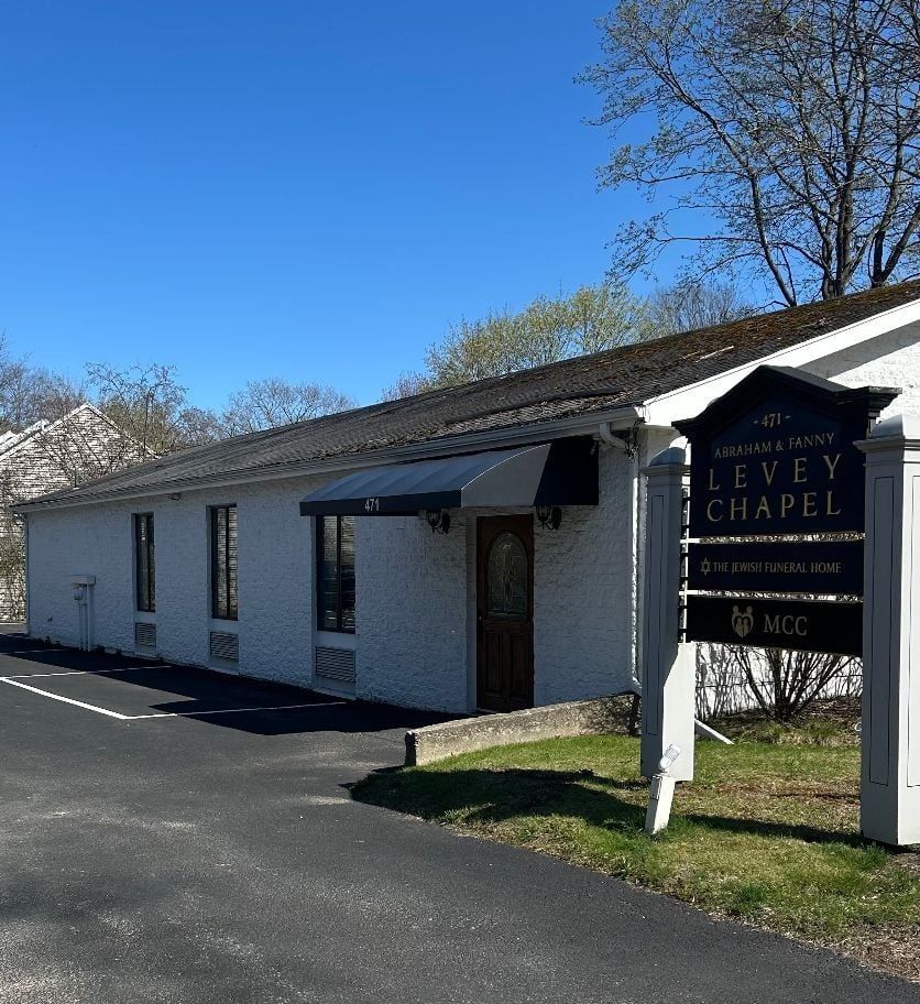 A church with rows of wooden benches and a podium