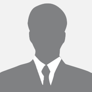 Silhouette of a person wearing a suit and tie, against a light gray background.