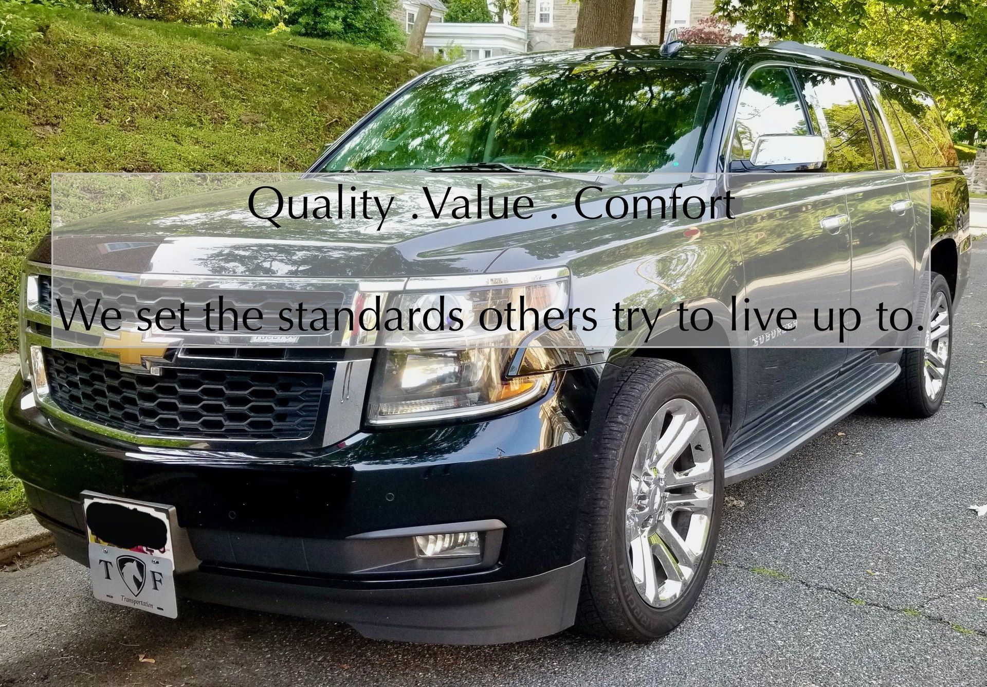 A black suv is parked on the side of the road.