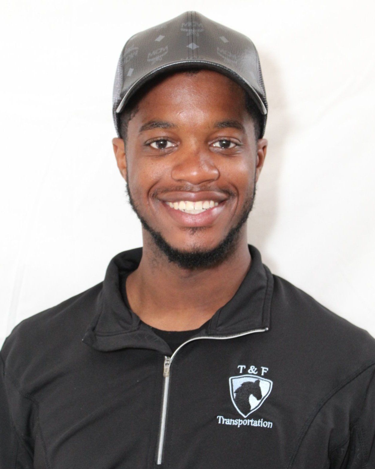 A man wearing a hat and a shirt that says t & p