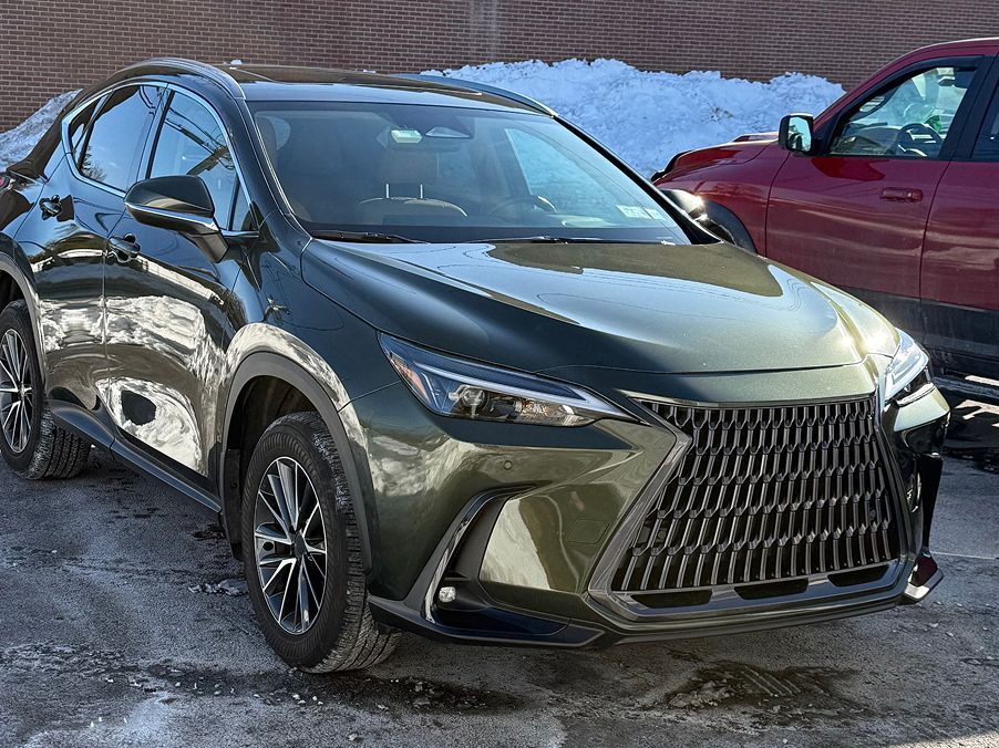 A dark olive-green Lexus NX SUV parked outdoors on an asphalt surface with patches of snow. | Big n' Littles Auto Body