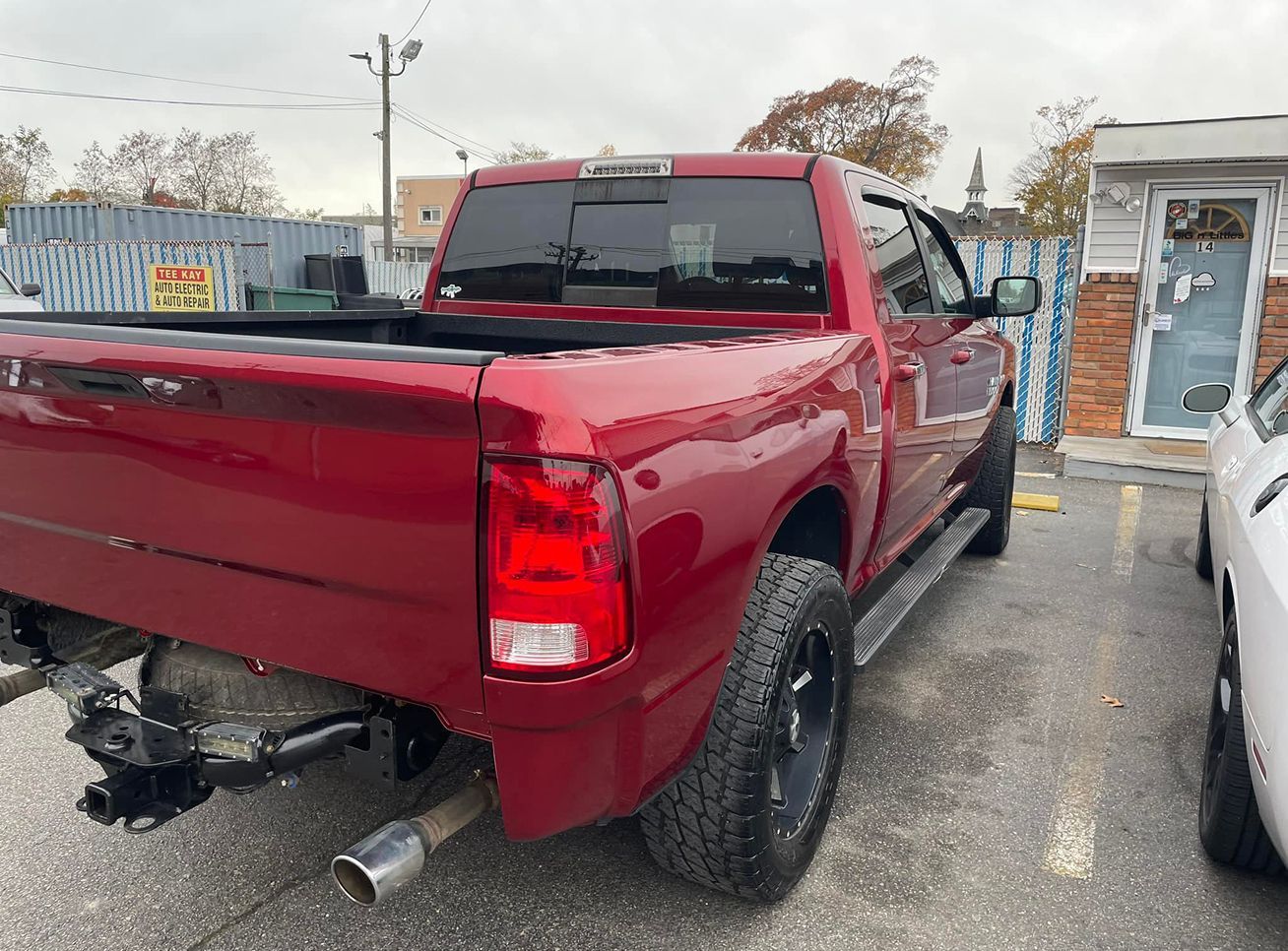 Red pickup truck parked outdoors. Tail lights and exhaust pipe are visible. | Big n' Littles Auto Body