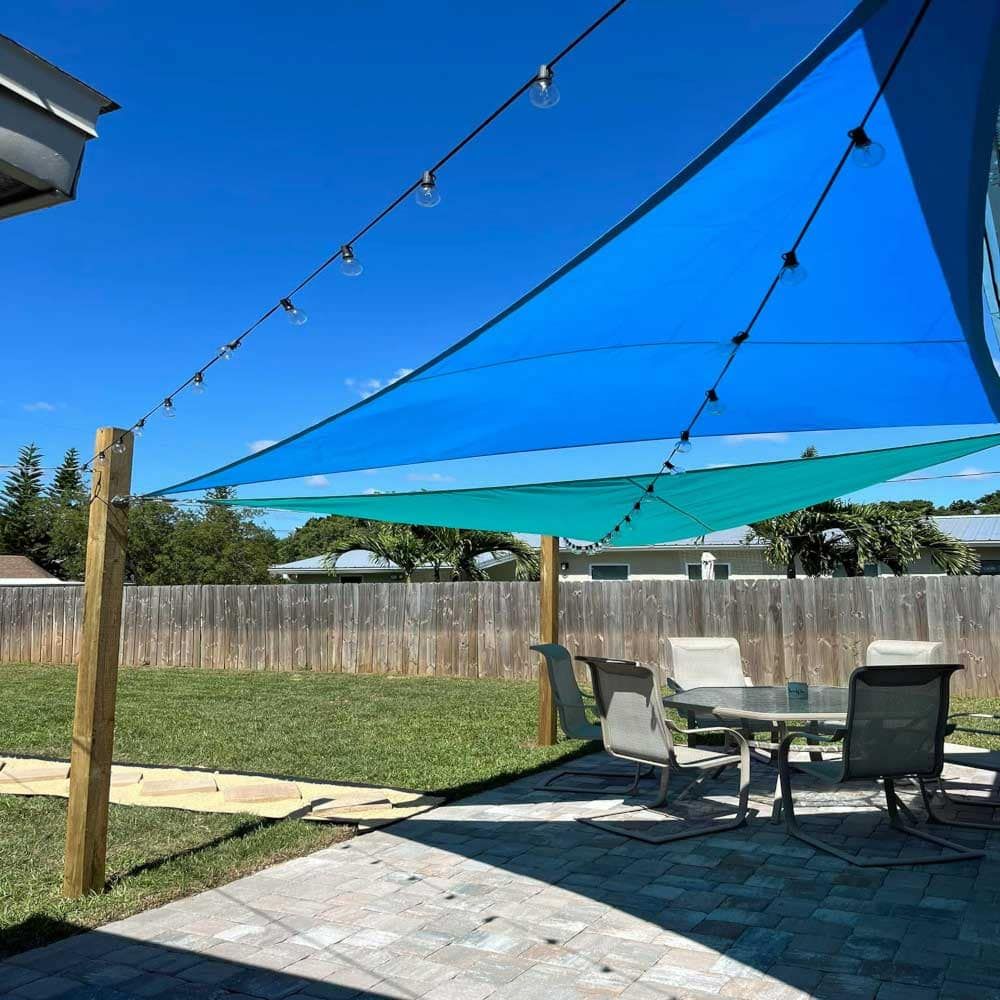 A patio with a table and chairs under a blue umbrella