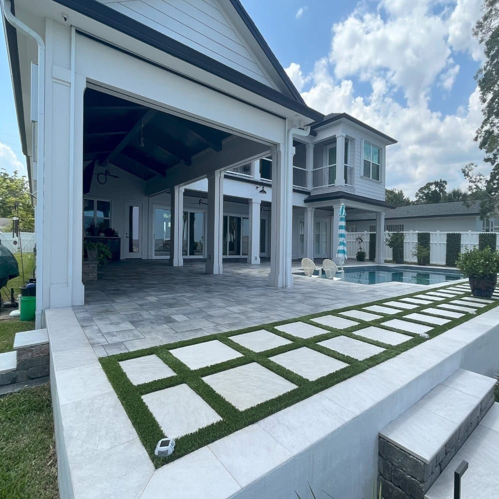A large white house with a swimming pool in the backyard