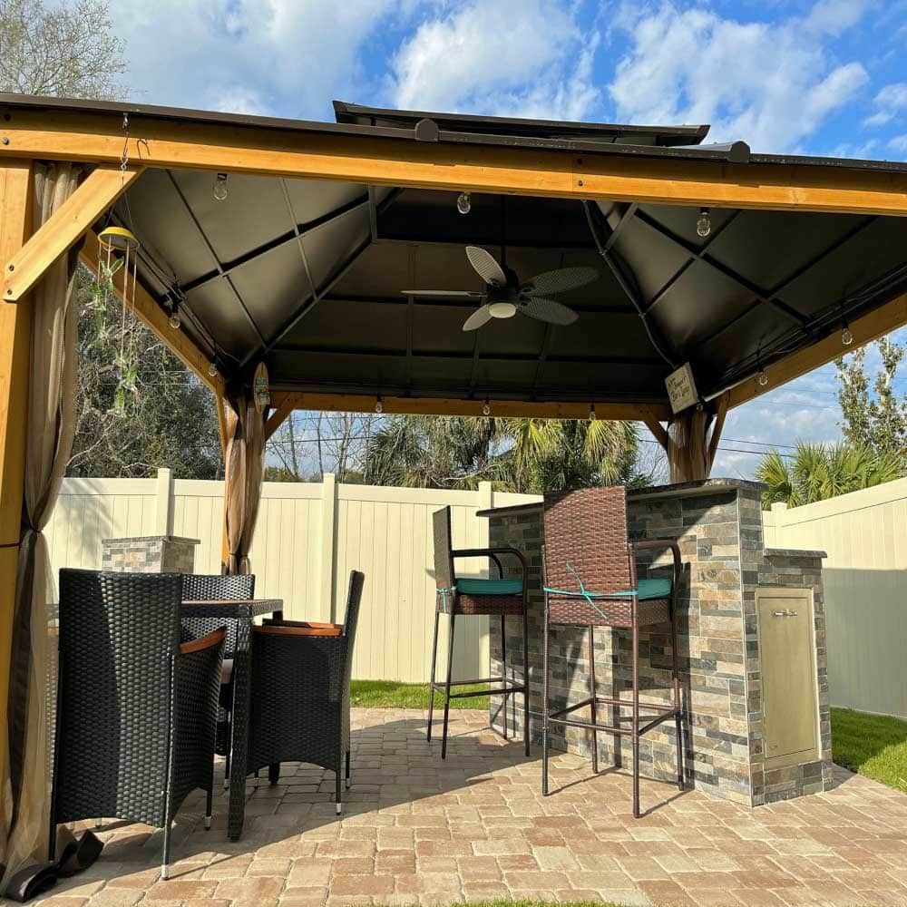 A gazebo with a table and chairs underneath it