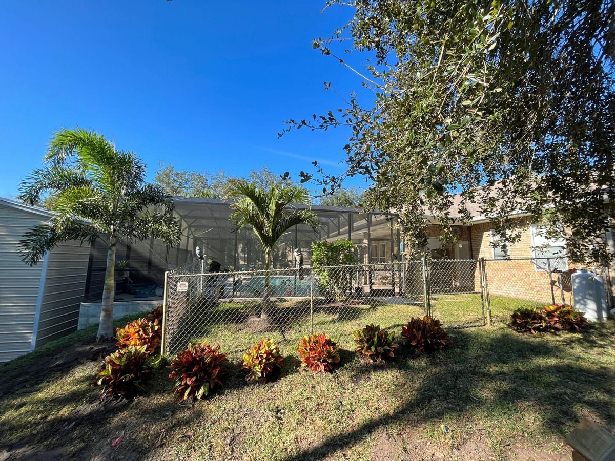 A house with a fence and a pool in the backyard.