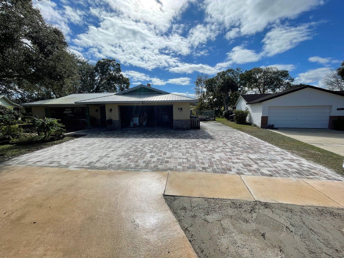 A house with a driveway and a garage in front of it.