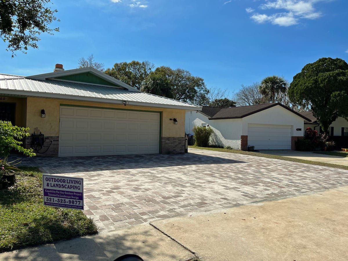 A white house with a purple sign in front of it.