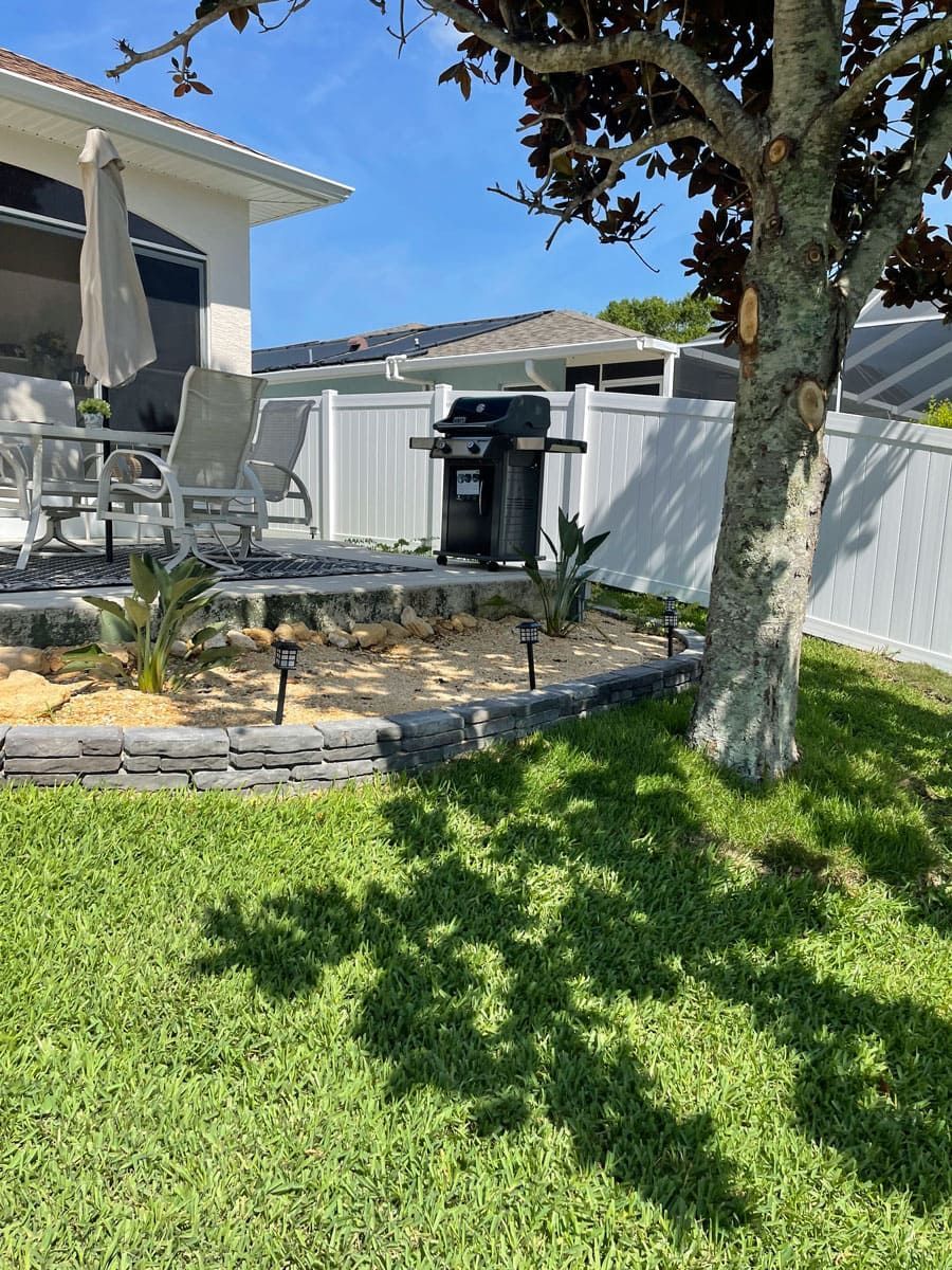 There is a grill in the backyard of a house.