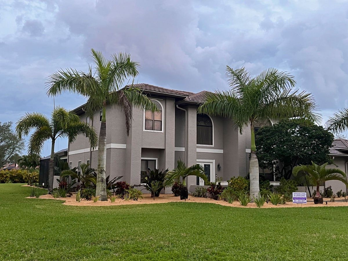 A large house with palm trees in front of it is for sale.